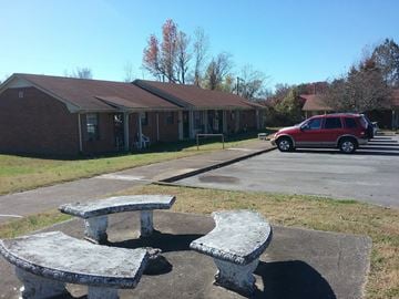 Mcewen apartment for rent - a picnic table and benches in front of a building